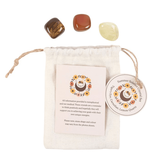 Crystal set with stones and a pouch on a white background