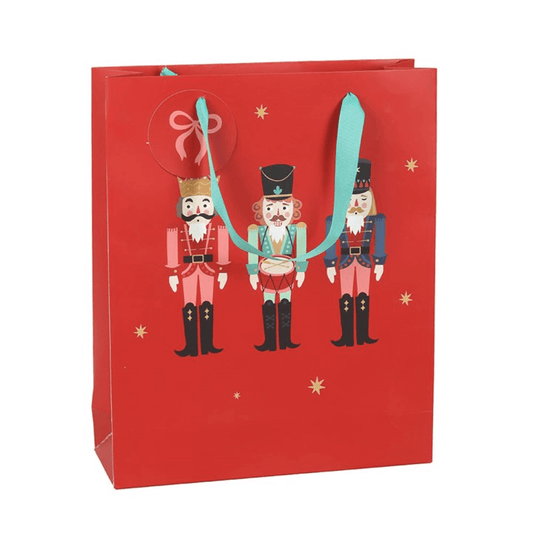 Red gift bag with nutcracker design on a white background