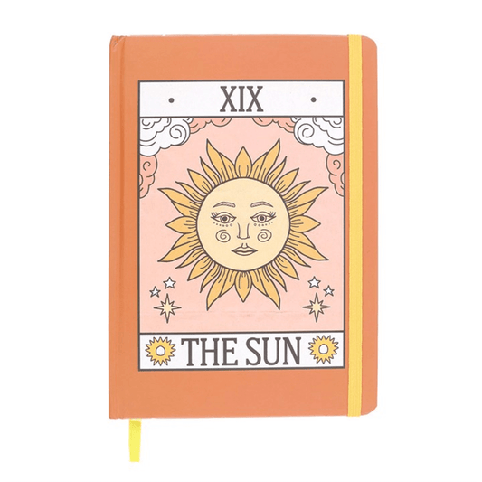 Notebook with 'The Sun' tarot card design on an orange cover