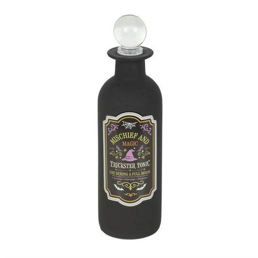 Decorative glass potion bottle labeled 'Mischief and Magic - Trickster Tonic' with a clear stopper lid.