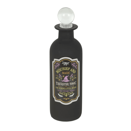 Decorative glass potion bottle labeled 'Mischief and Magic - Trickster Tonic' with a clear stopper lid.