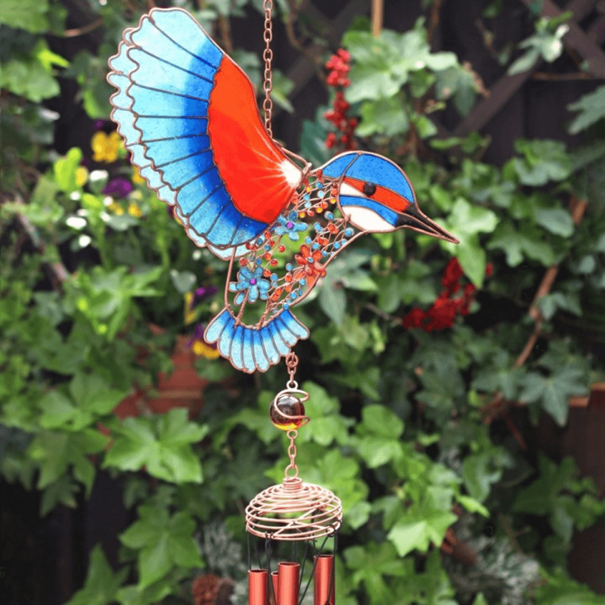 Decorative wind chime shaped like a colorful bird with a green leafy background
