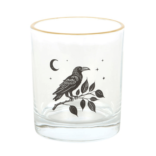 Clear glass tumbler with a black bird and leaf design on a white background