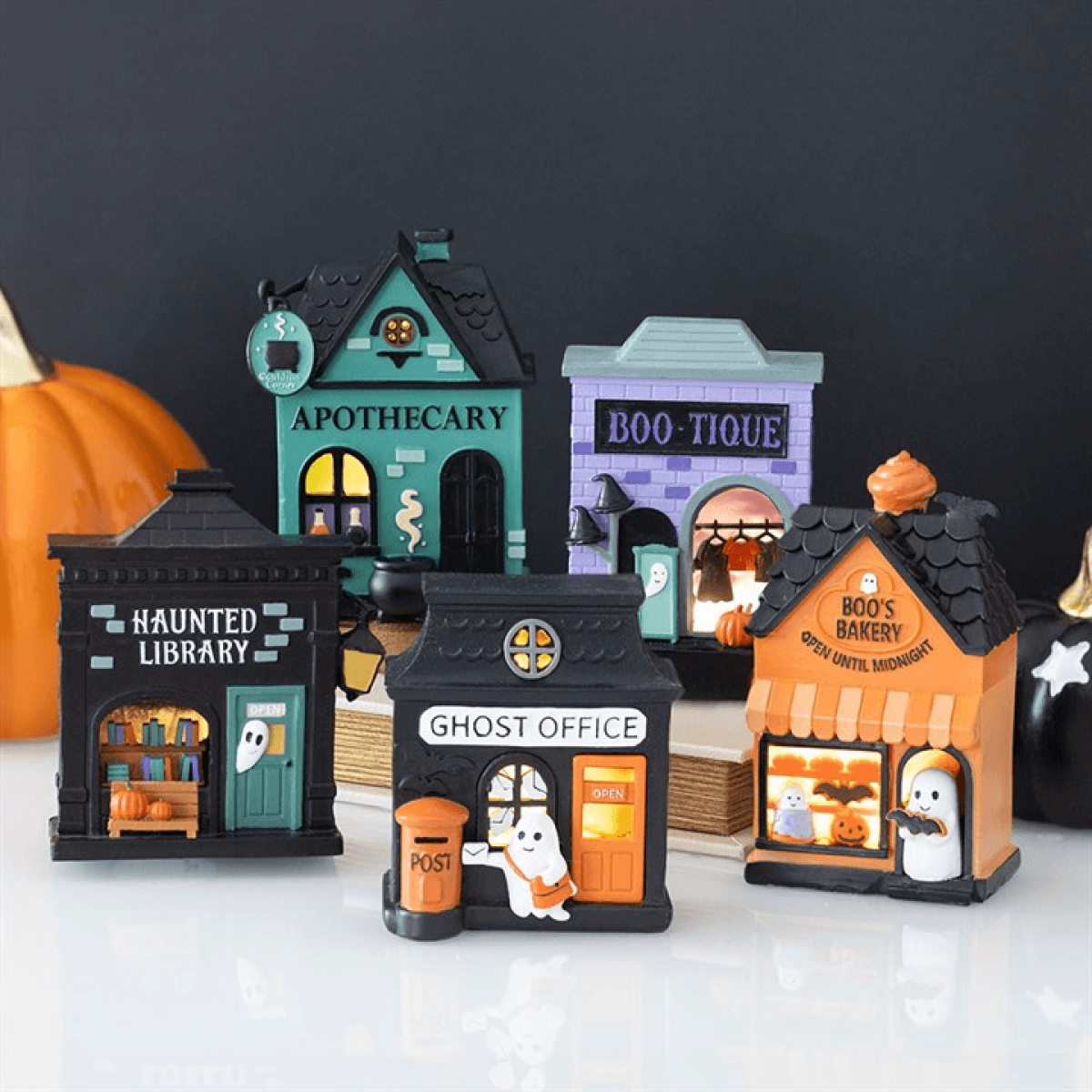 Apothecary Shop LED light up decoration among Halloween-themed miniature buildings.