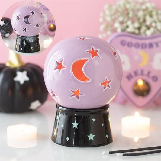 Crystal ball tealight candle holder in purple with crescent moon and star cut-outs for magical lighting.