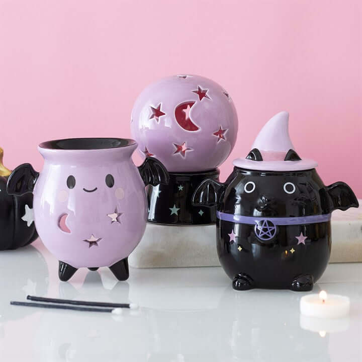 Pastel Bat Brew cauldron oil burner collection featuring playful designs and whimsical details.