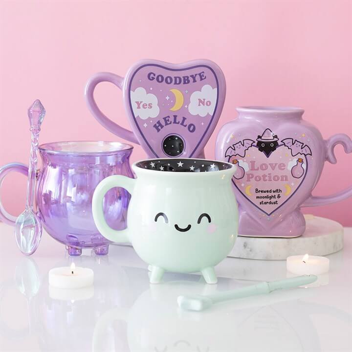 Pastel Potion Shaped Mug and magical mugs collection on display with candles.