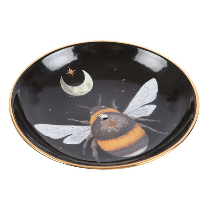 Black dish with a bee and moon design on a white background