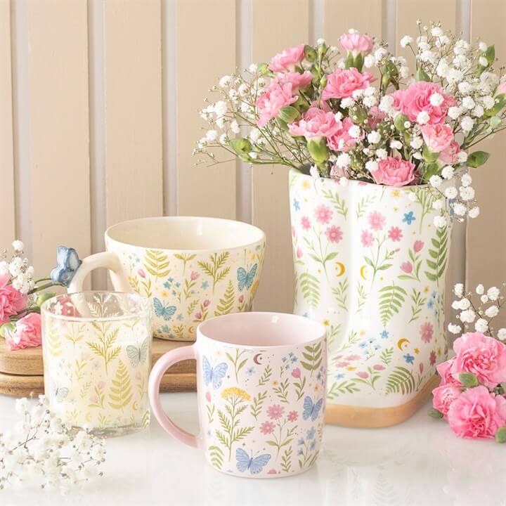 Luna Bloom Floral Print Welly Boot Planter with flowers and decorative cups. Perfect for plant lovers and indoor decor.