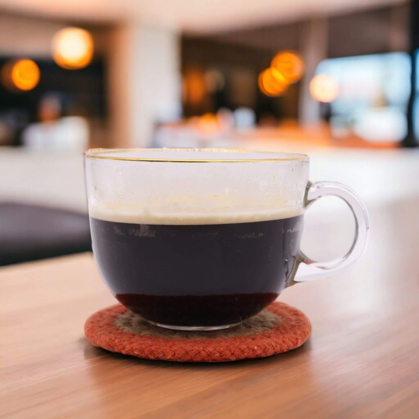 Cotton Natural Coaster under a coffee cup, showcasing the jute and cotton design in a cozy setting.