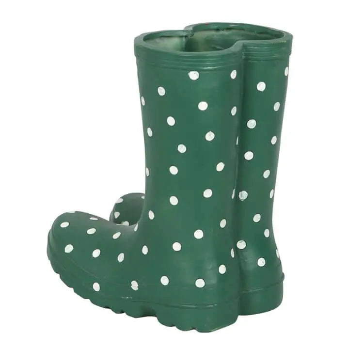 Green rain boots with white polka dots on a white background