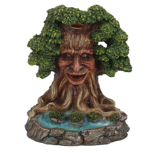 Tree-like figurine with face and foliage on a white background