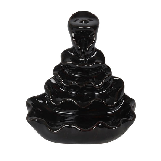 Black ceramic incense burner with wavy design on a white background