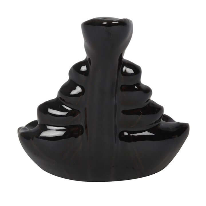 Black ceramic incense burner on a white background