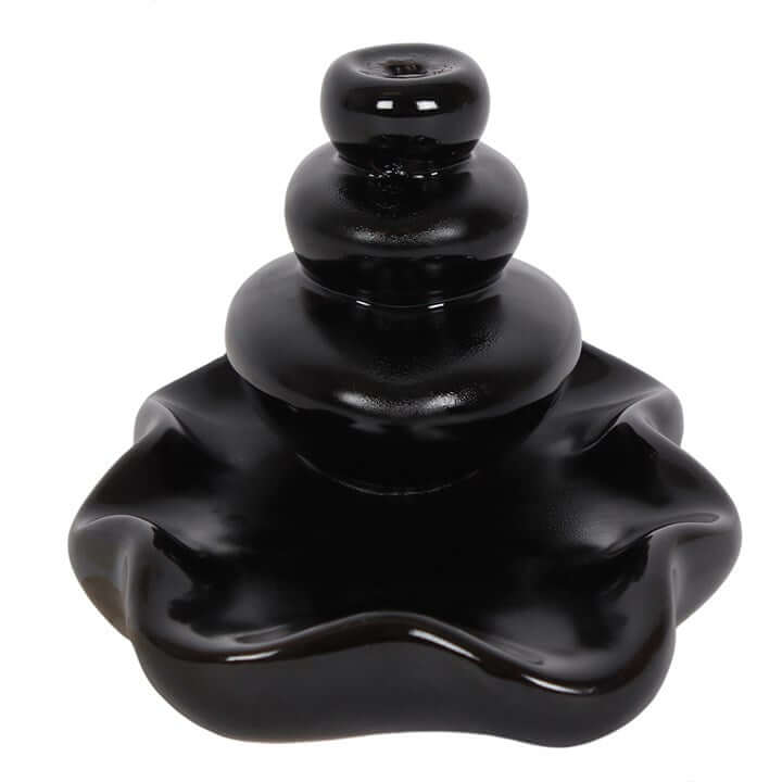 Black ceramic incense burner with layered design on a white background