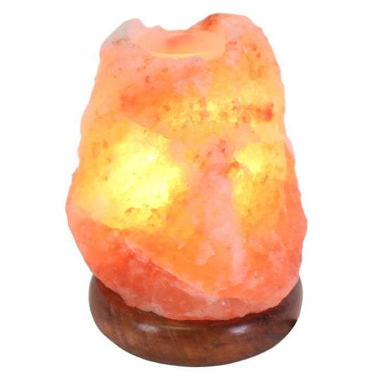 Himalayan salt lamp with wooden base on a white background