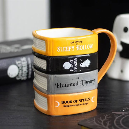 The Haunted Library Book Stack Mug designed to resemble a stack of spooky books, perfect for cozy reading sessions.