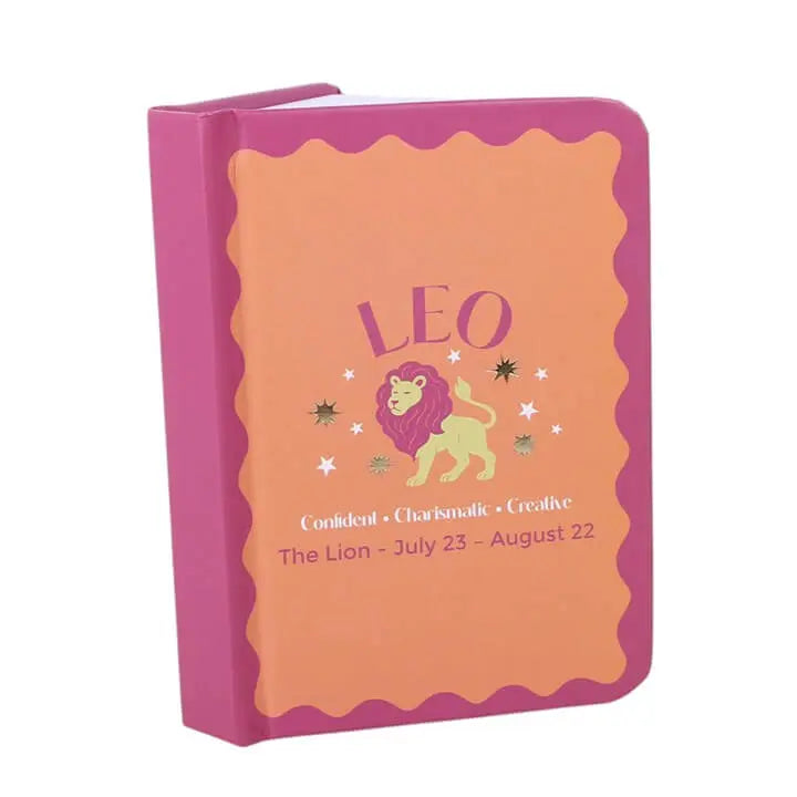 Leo Gift Set featuring a colorful notebook with the text 'LEO' and lion graphic, highlighting Leo traits.