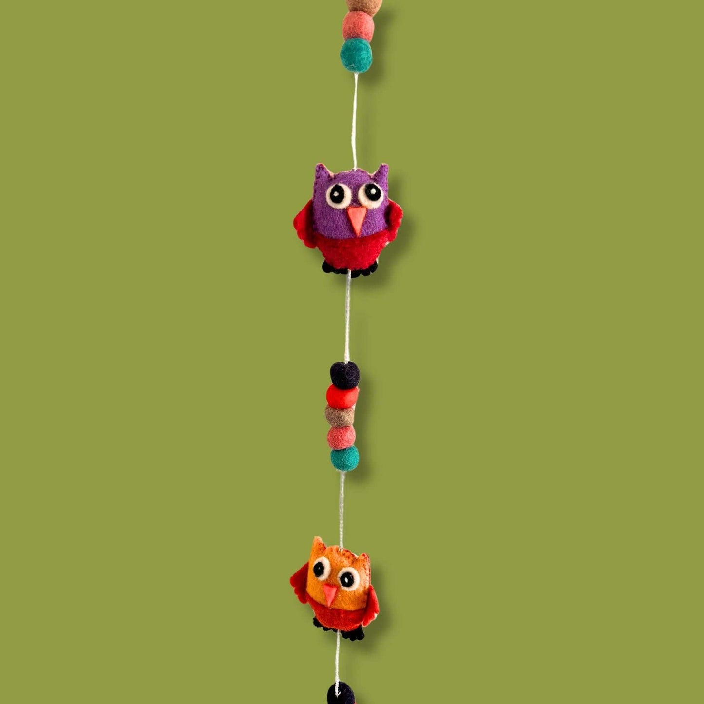 Felt Wall Hanging Owls in random colours featuring cute purple and orange designs on a green background.