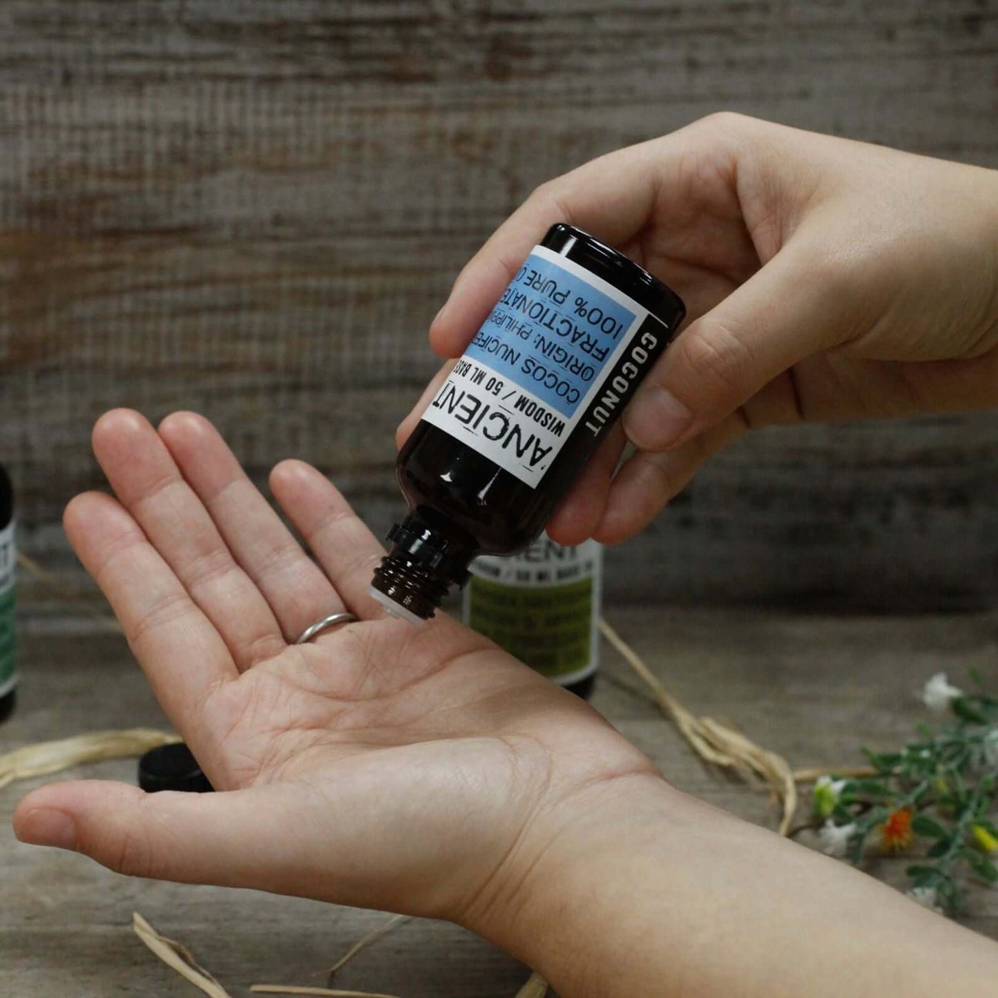 Apricot Kernel Oil - 50ml being applied to palm for skincare benefits.