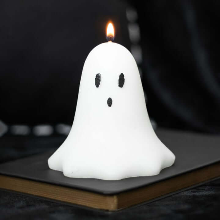 10cm Unscented Ghost Candles illuminating a dark background, perfect for Halloween decor.