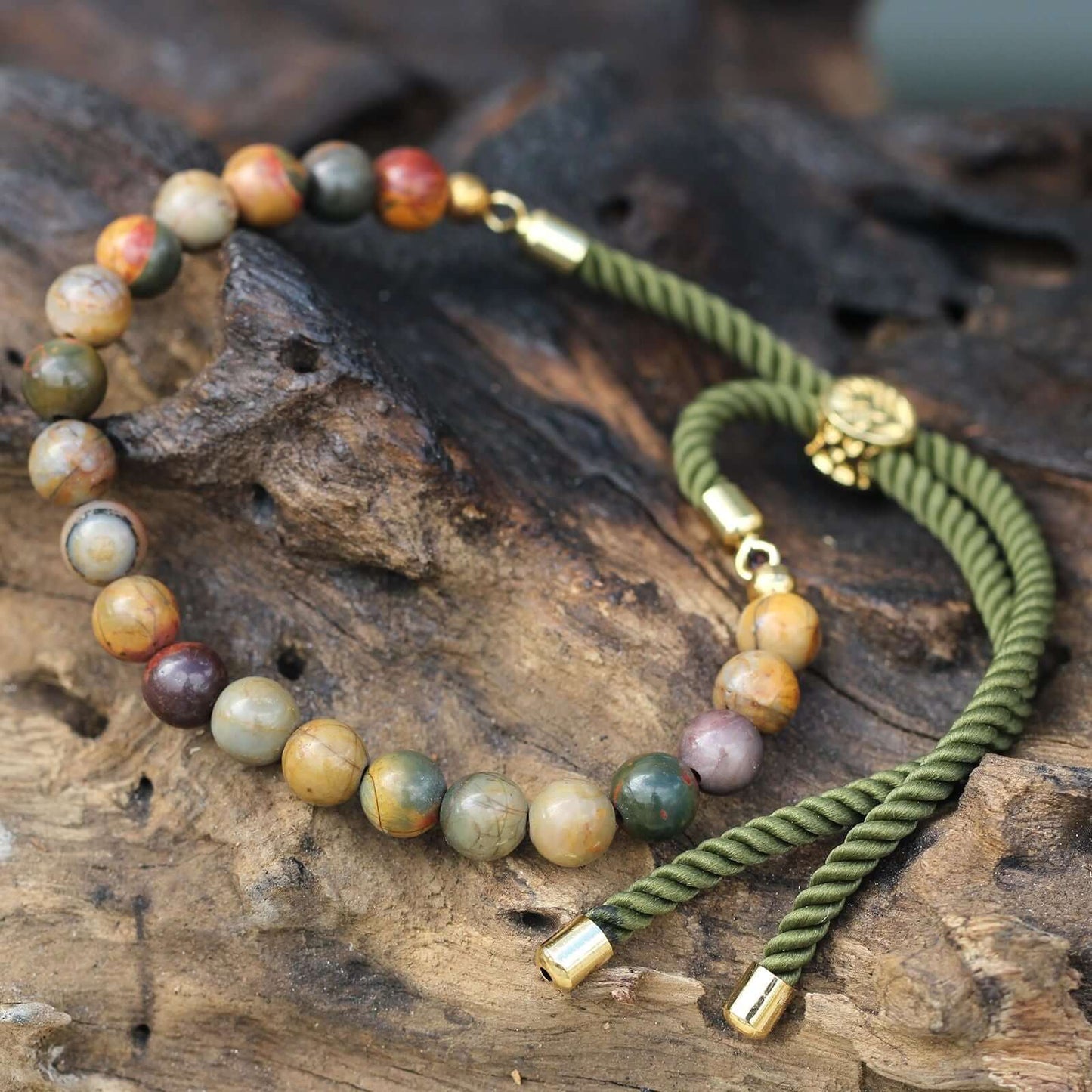 18K Gold Plated Gemstone Moss String Bracelet featuring Picasso Jasper on a wooden background.
