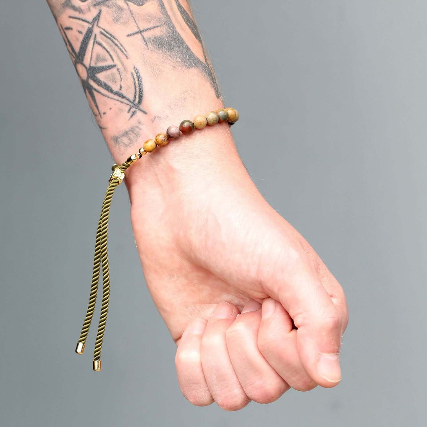 18K Gold Plated Gemstone Moss String Bracelet on wrist featuring Picasso Jasper and adjustable toggle.