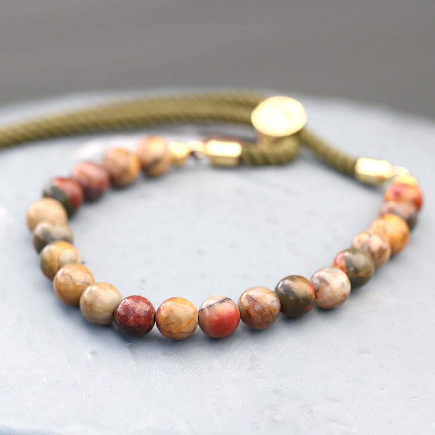 18K Gold Plated Gemstone Moss String Bracelet featuring Picasso Jasper beads and adjustable rope strings.