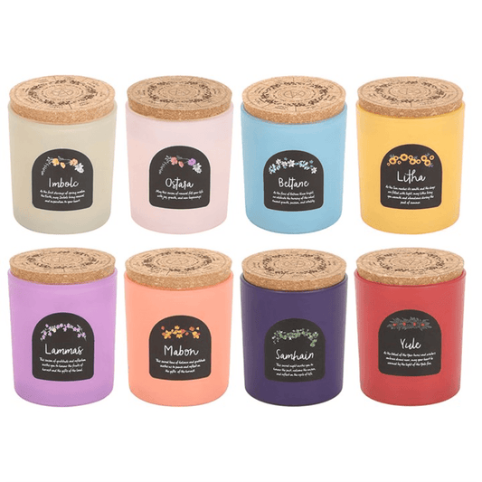Set of 8 Wheel of the Year Candles in colorful jars with cork lids, perfect for seasonal celebrations and rituals.