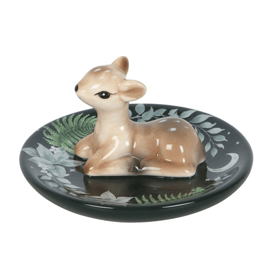Ceramic deer figurine on a decorative plate with nature-themed design