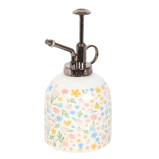 White spray bottle with floral pattern on a white background