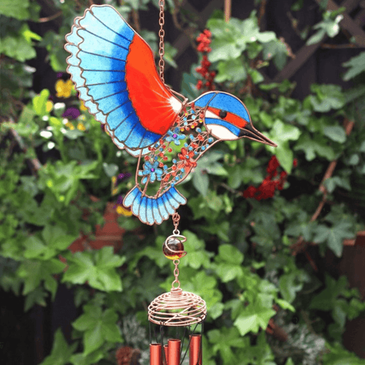 Decorative wind chime shaped like a colorful bird with a green leafy background