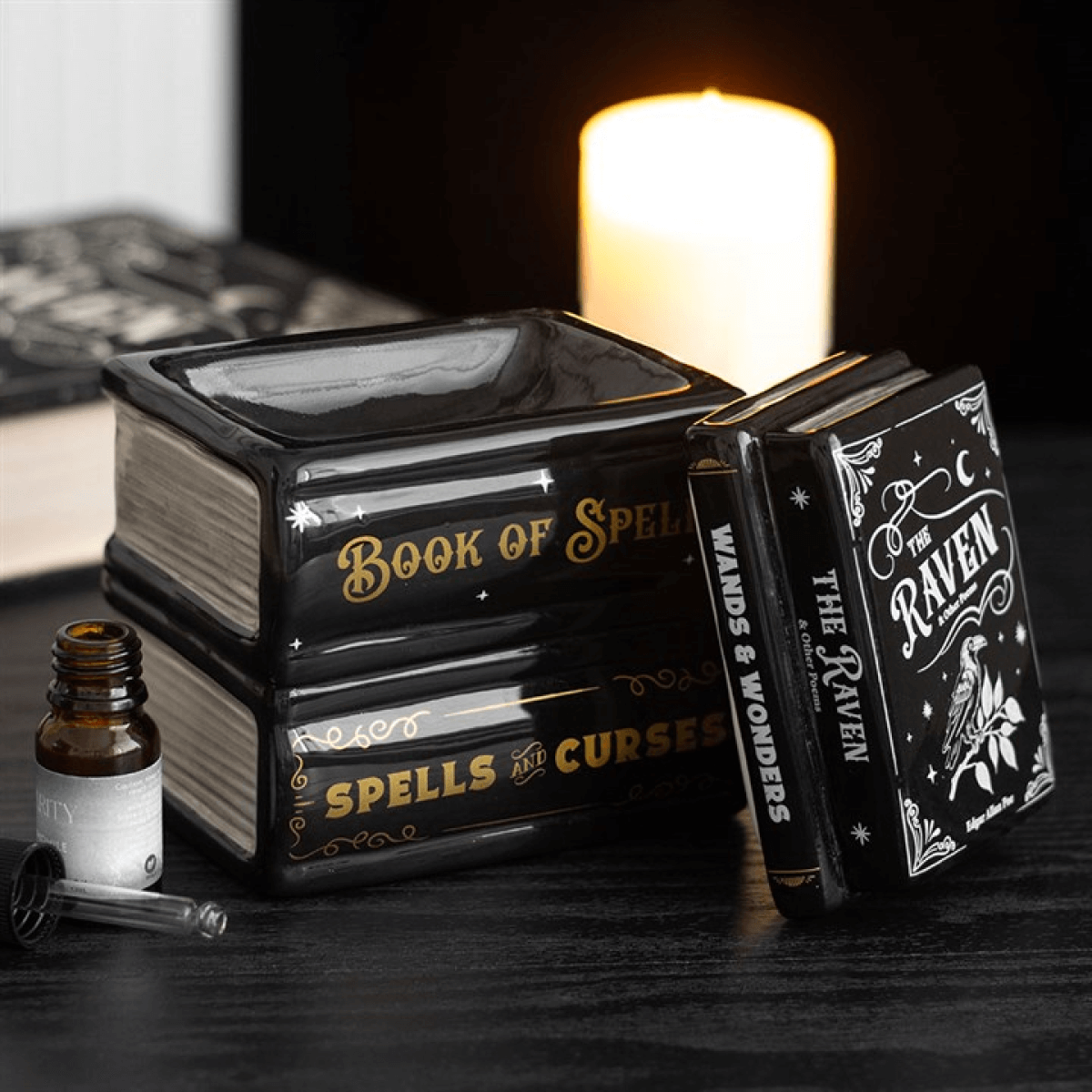 Book of Spells oil burner designed as stacked spell books with magical fragrances and gothic décor.