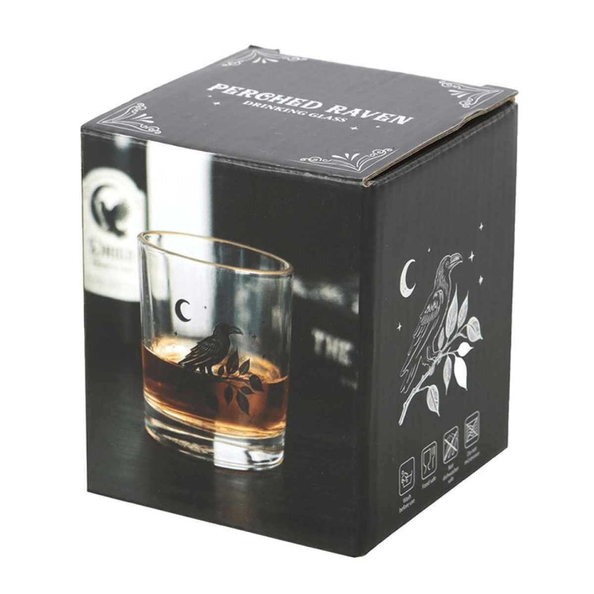 Whiskey glass with engraved raven design in a branded box on a white background