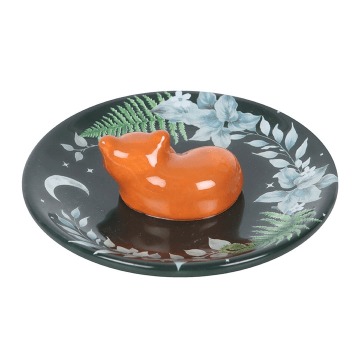 Orange cat-shaped object on a decorative plate with floral patterns