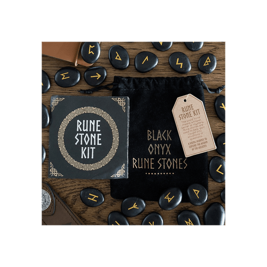 Set of 25 Black Onyx Rune Stones and Rune Stone Kit displayed on a wooden table, highlighting Norse mythology elements.
