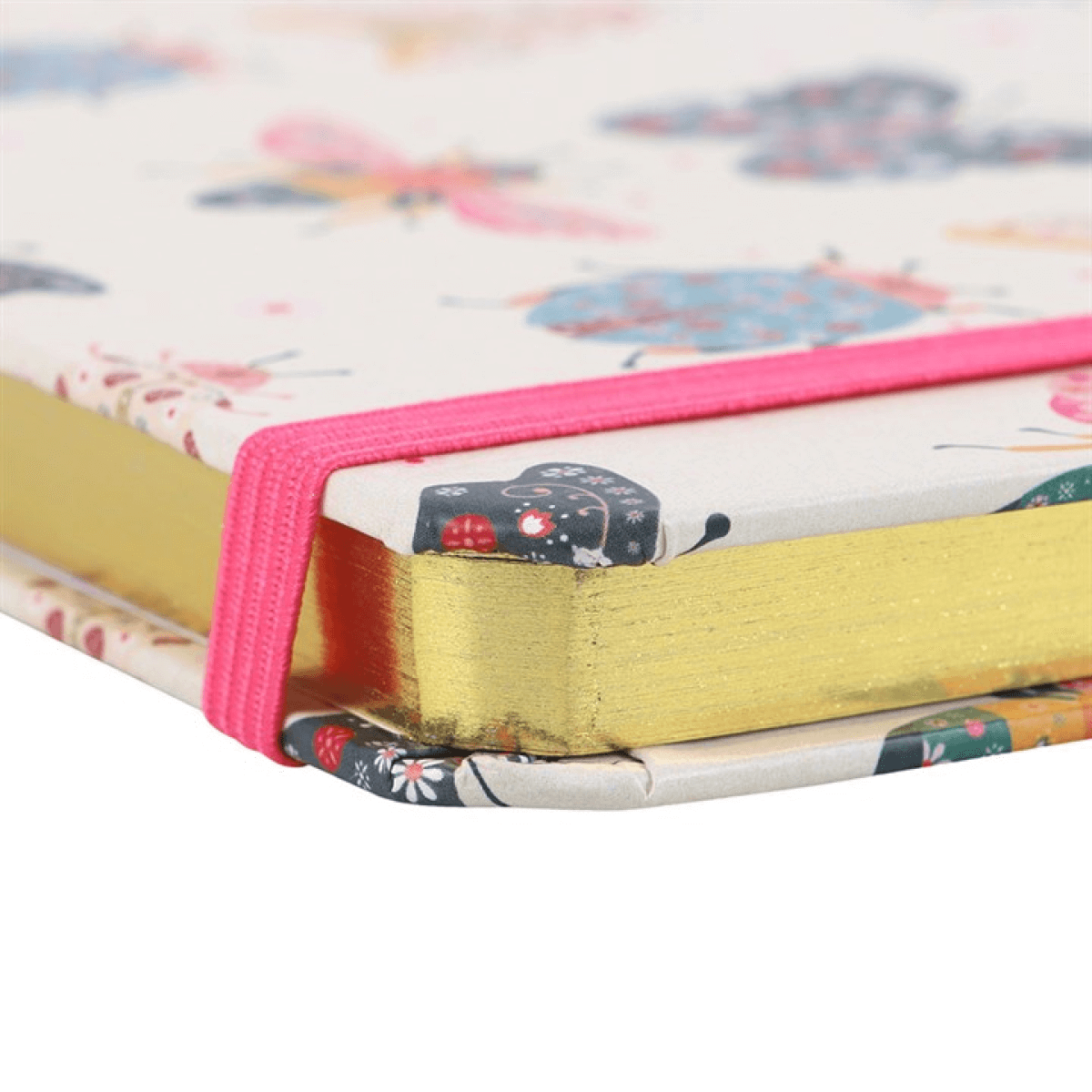 Close-up of a notebook with colorful cover and pink binding