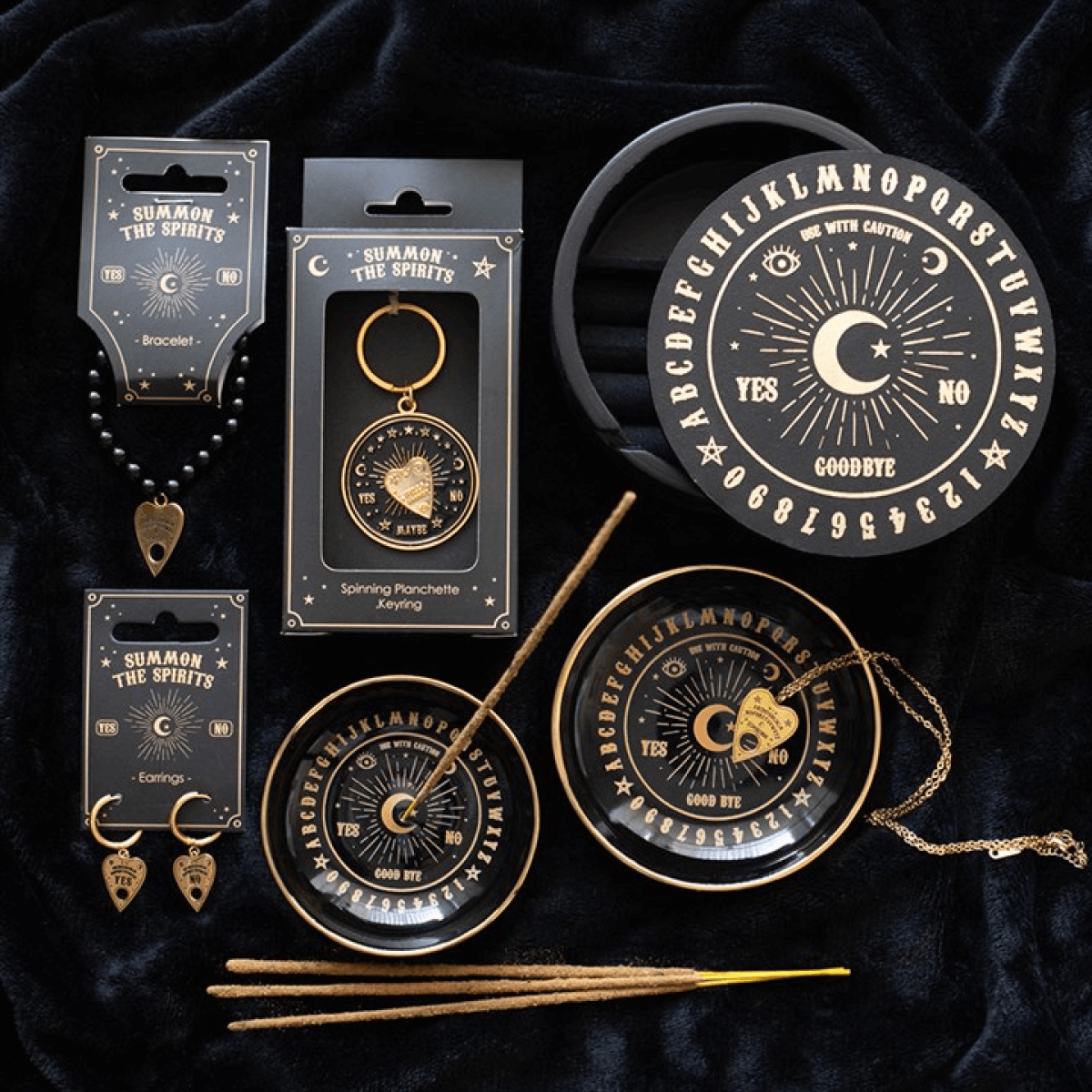 Witchcraft-themed product set including keychain, earrings, and decorative items on a dark background.