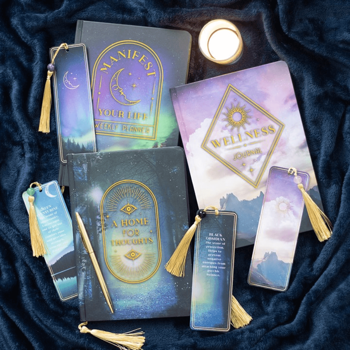 Set of books and bookmarks with tassels on a dark fabric background