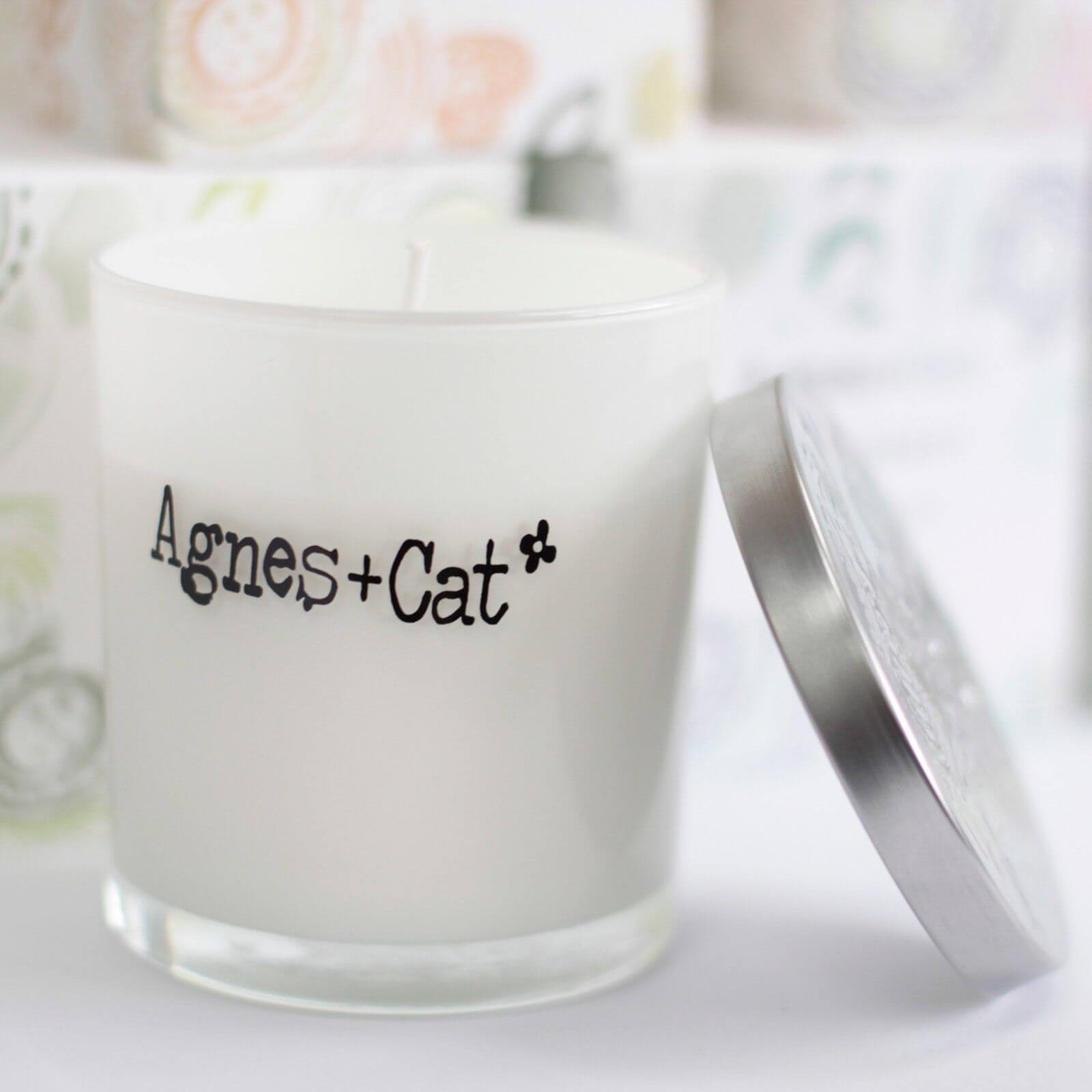 Agnes + Cat Votive Candle with silver lid, showcasing fresh citrus scent in a clear glass container.