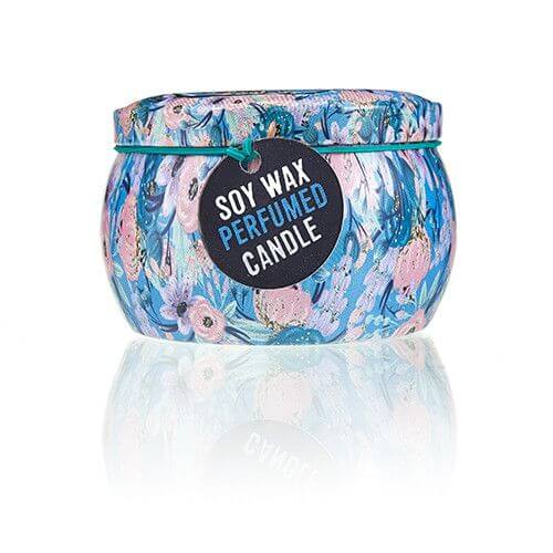 Art Tin Candle with floral design, soy wax, and a tag reading 'Perfumed Candle' against a reflective surface.