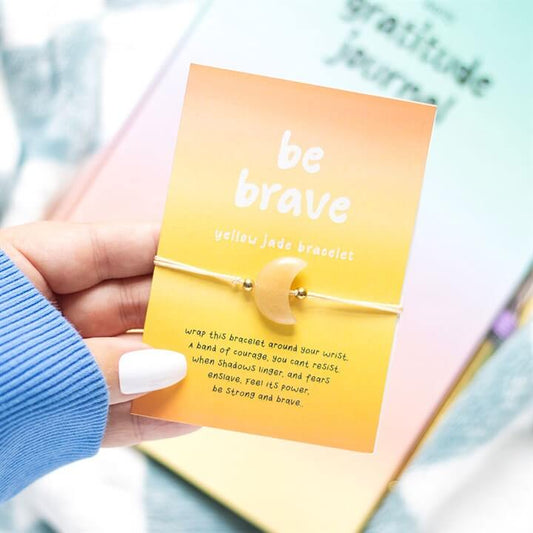Be Brave Yellow Jade Crystal Moon Bracelet displayed on a card with inspirational text, featuring a yellow jade crescent moon charm.