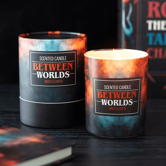 Two artistic Between Worlds Moss & Earth Candles displayed with vibrant labels, designed for an immersive candle experience.