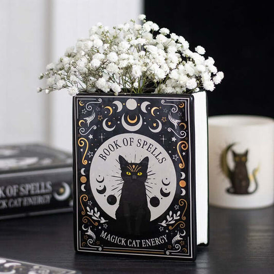 Black Cat Magick Book Shaped Flower Vase with flowers, perfect for adding charm and style to your decor.