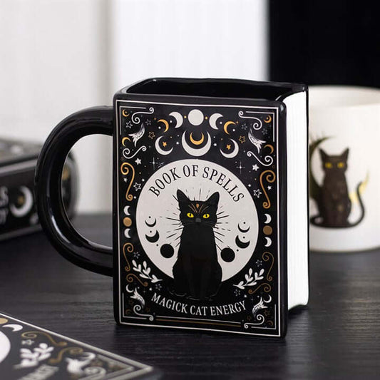 Book Shaped Mug featuring a black cat and mystical designs, perfect for spell reading sessions.