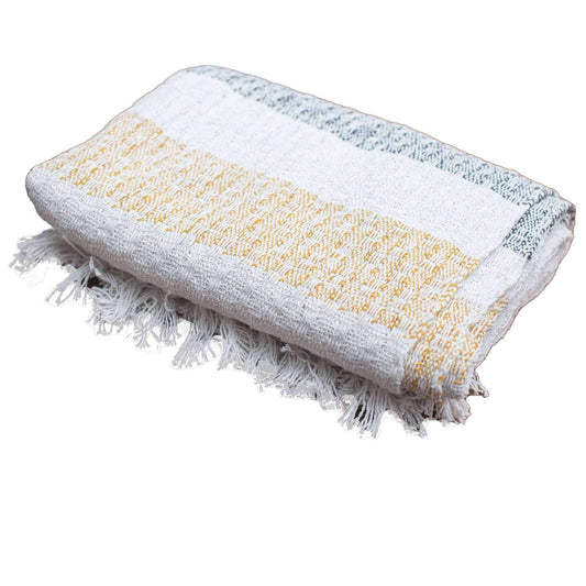 Boho Comfort Throws - Mellow Mattala cotton throw with cream, golden, and grey stripes, featuring tasselled edges.