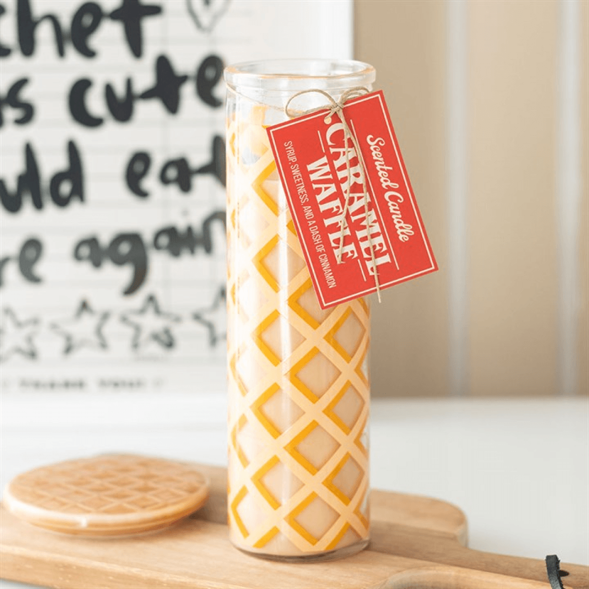 Caramel Waffle Scented Tube Candle displayed on a wooden surface with a decorative tag, enhancing home fragrance.