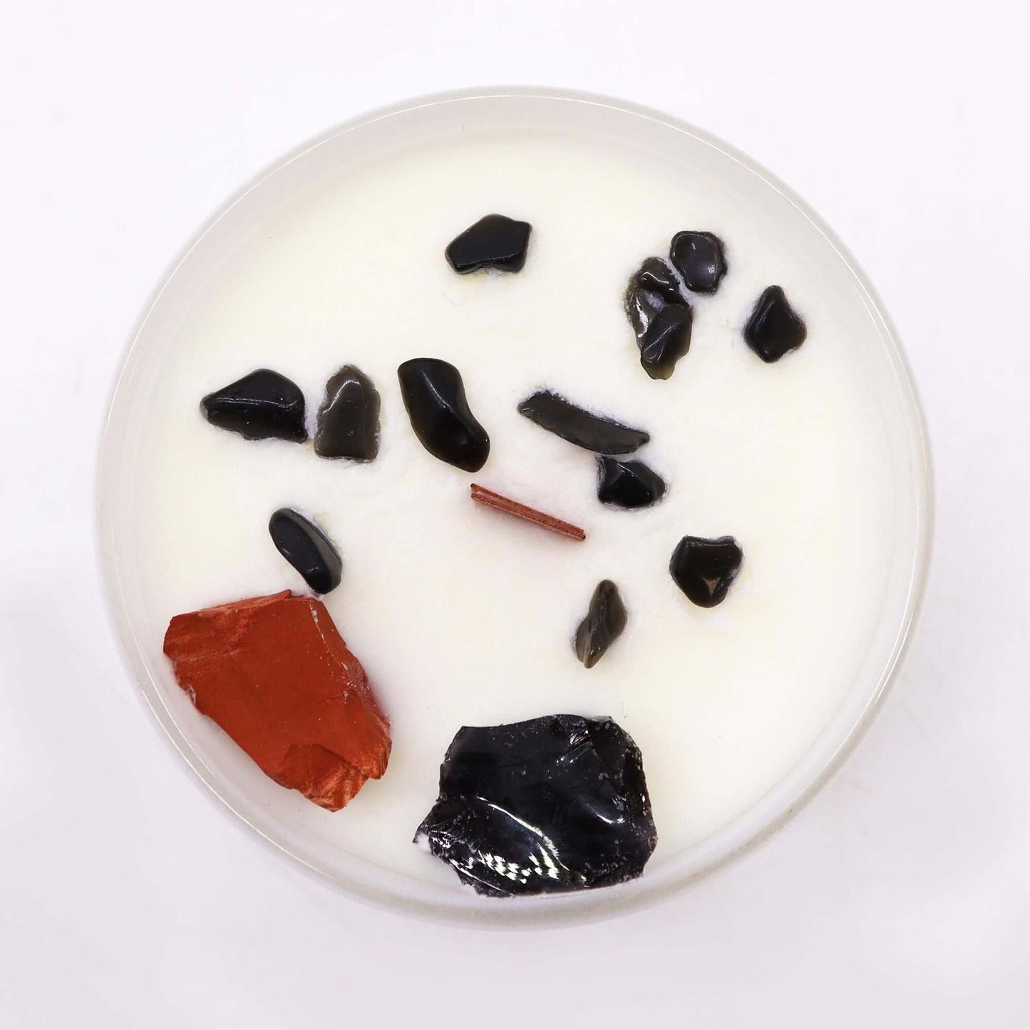 Chakra Crystal Candle - Root Chakra with Black Oud fragrance, featuring crystals and a white wax base.
