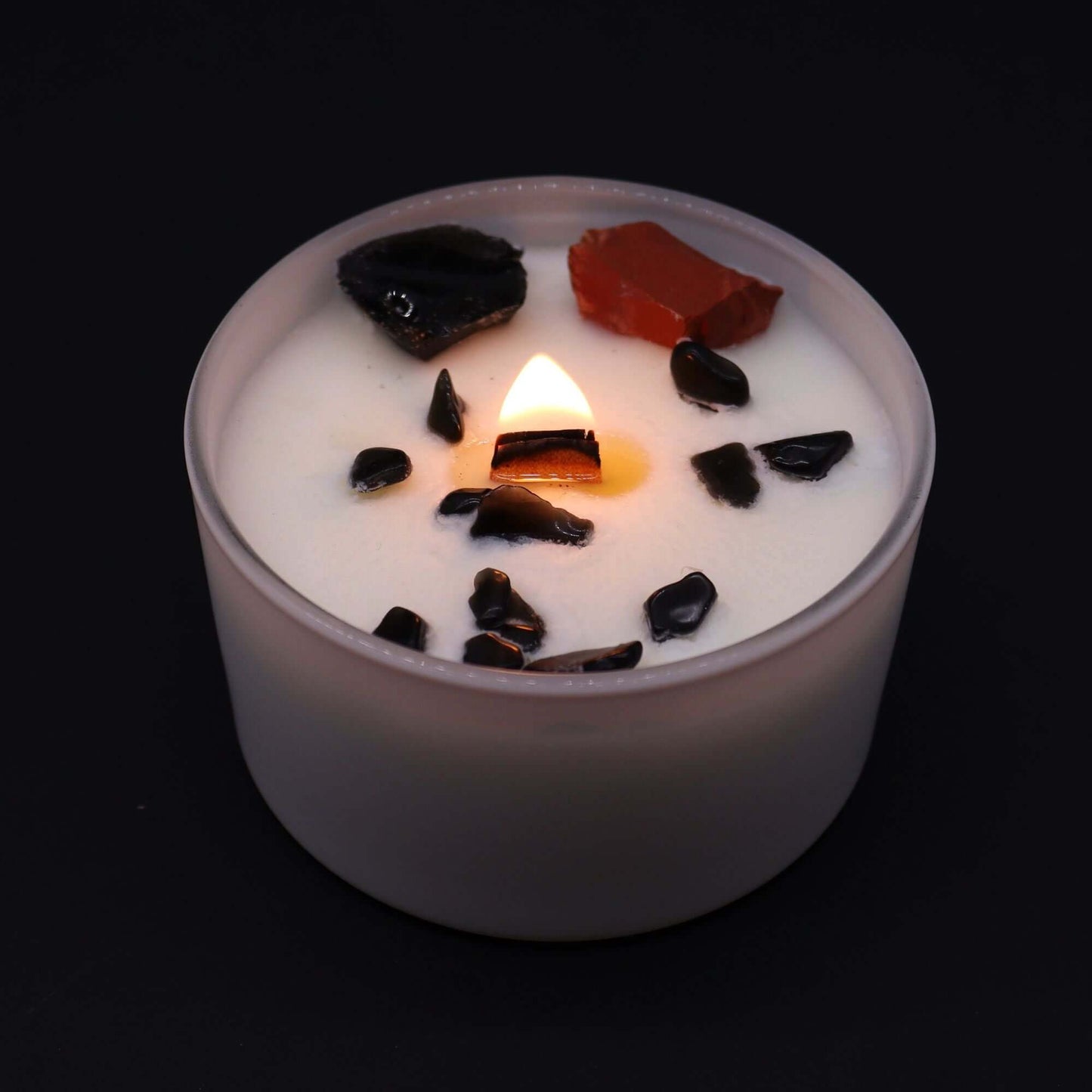 Chakra Crystal Candle featuring Root Chakra stones and a warm flame, symbolizing stability and security.