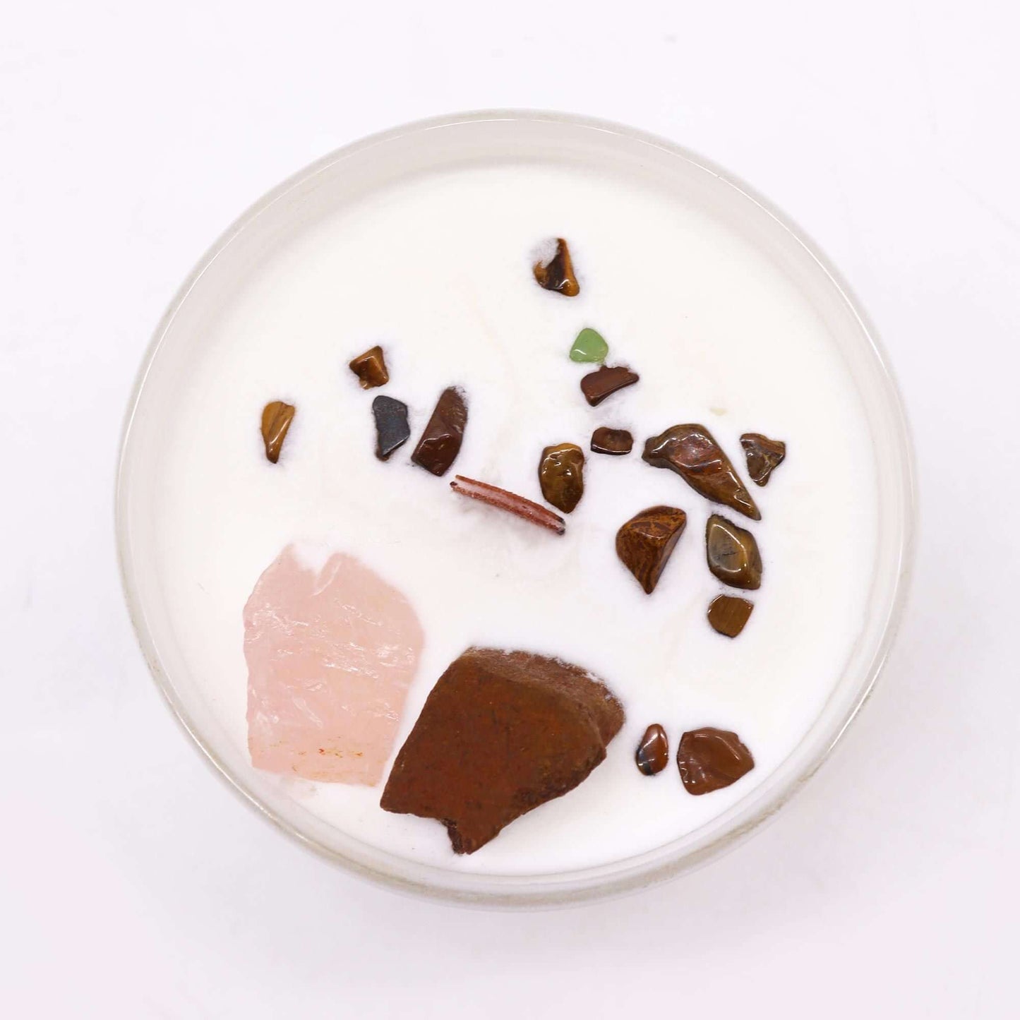 Top view of a Chakra Crystal Candle featuring stones for the Sacred Chakra, promoting creativity and passion.